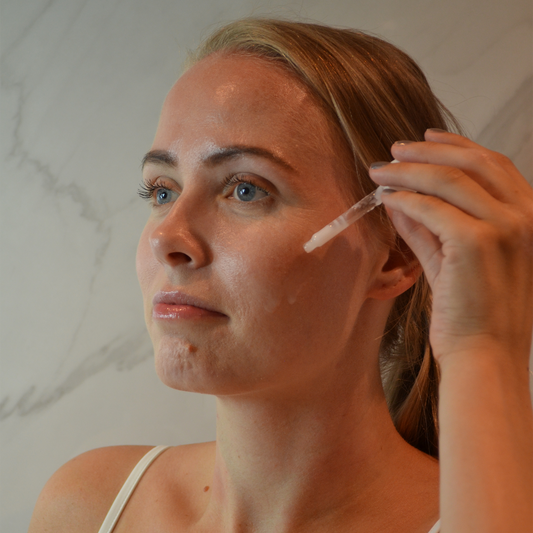 Bilde av dame som påfører The Potions Azulene Ampull i ansiktet